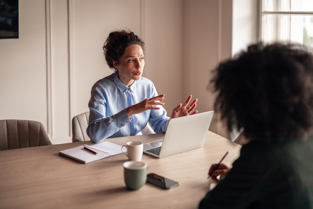 Two,Colleagues,Engage,In,A,Focused,Business,Discussion,At,A